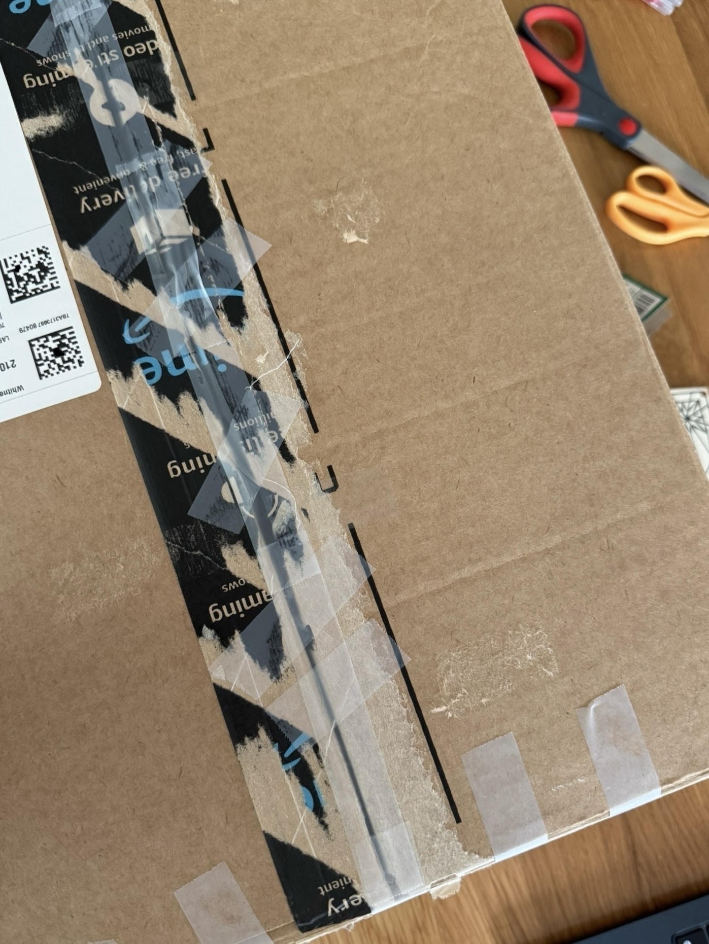 A cardboard package resealed with lots of tape.