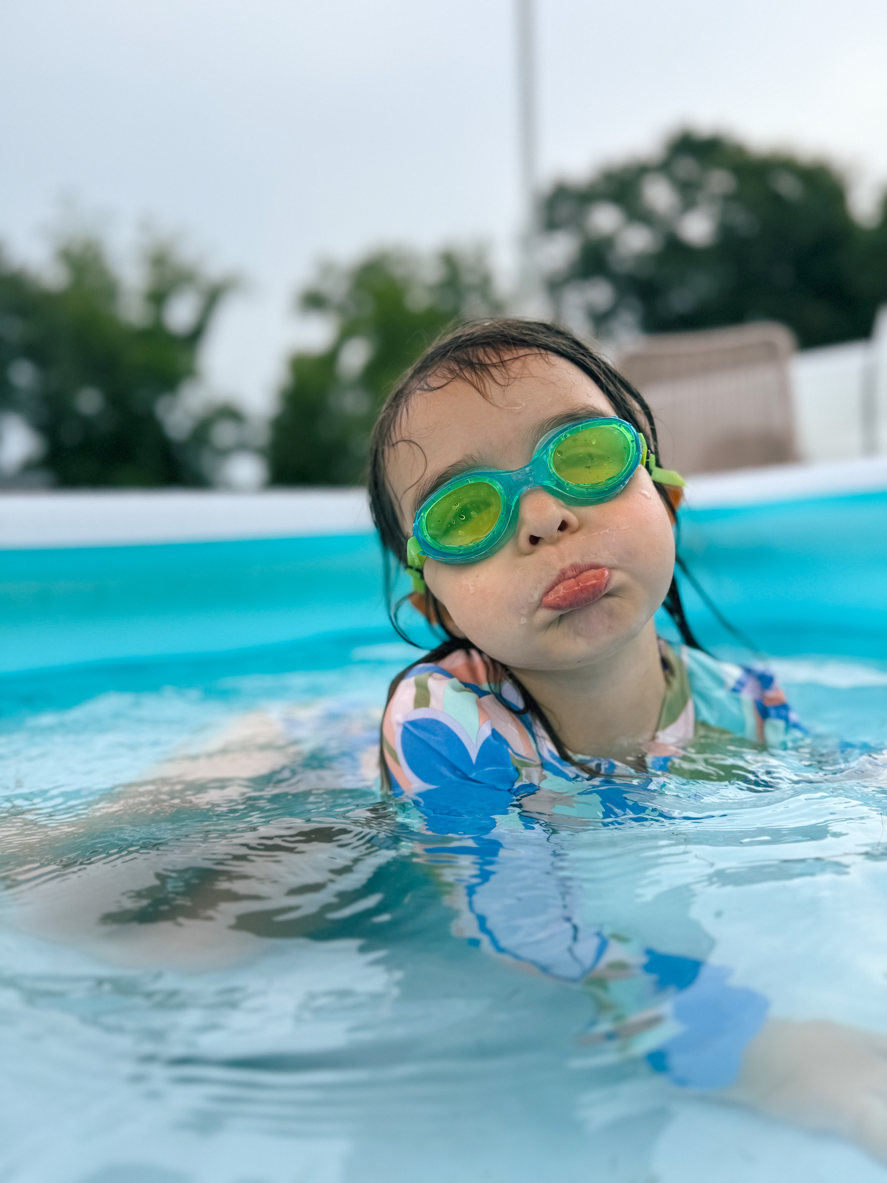 A girl in swimming goggles